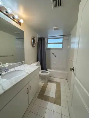 a white bathroom with a sink and a toilet at Bright 2BR Apartment in Prime Brickell Location in Miami