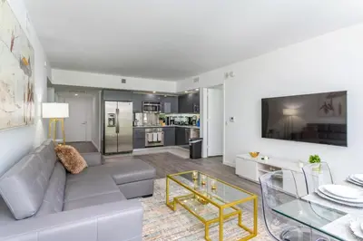a living room with a couch and a table at Spacious and bright in the heart of Brickell in Miami