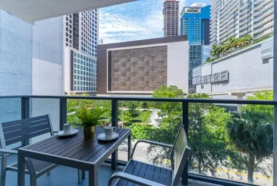 a balcony with a table and chairs and a view of a city at Spacious and bright in the heart of Brickell in Miami