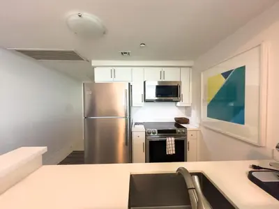 a kitchen with a stainless steel refrigerator and microwave at Miami top stay is nearly sold in Miami