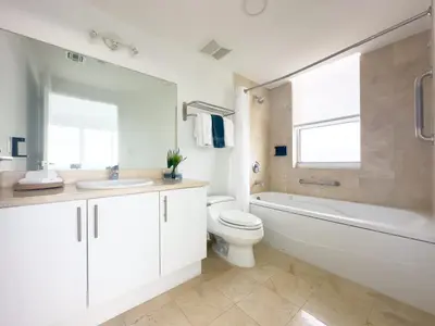 a bathroom with a toilet and a tub and a sink at Miami top stay is nearly sold in Miami