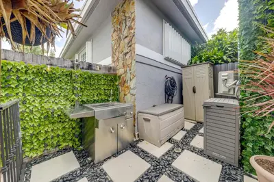 a bathroom with a sink and a toilet at Mod Bungalow with Ultra-Private Outdoor Hang Space! in Miami Gardens