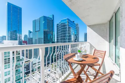 a balcony with a table and chairs and a city skyline at Fantastic APT Brickell in Miami
