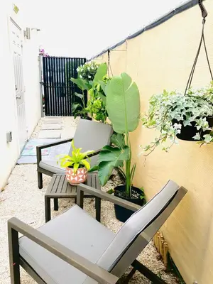 a patio with two benches and potted plants at Retreat Independent Entire Room in Princeton