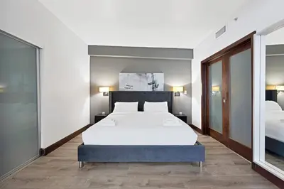 a bedroom with a large bed and two beds at Heart of South Beach Balcony Rooftop Pool in Miami Beach