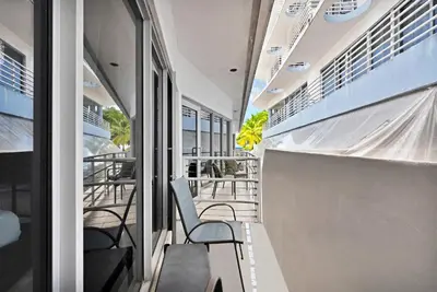 a corridor of a building with chairs and windows at Heart of South Beach Balcony Rooftop Pool in Miami Beach