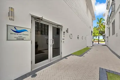 a white building with a sign on the side of it at Stylish Studio in South Beach with Ocean Views in Miami Beach