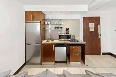 a kitchen with a refrigerator and a sink at Heart of the Ocean Drive 1BDR Rooftop Pool with cabanas in Miami Beach