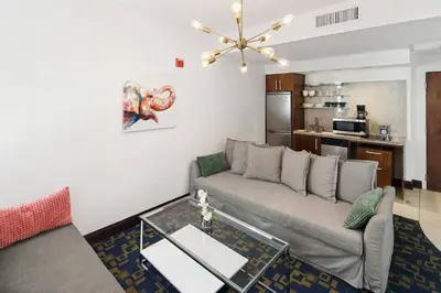 a living room with a couch and a table at Heart of the Ocean Drive 1BDR Rooftop Pool with cabanas in Miami Beach