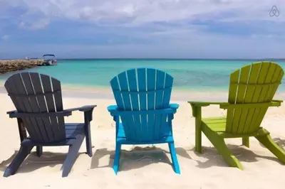 two chairs and a table on the beach at Ocean Drive 1BDR Rooftop Pool with cabanas in Miami Beach