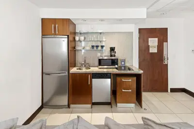 a kitchen with a refrigerator and a sink at Ocean Drive 1BDR Rooftop Pool with cabanas in Miami Beach
