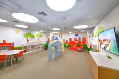 a childrens room with a table and chairs and a play area at Modern Doral Condo w Free Parking in Miami
