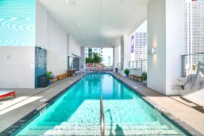 a large swimming pool in a building at Luxury Condo w Rooftop Pool & Gym in Miami