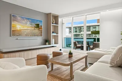 a living room with a couch and a tv at 2 Bedroom Private Residence at Roney Palace -630 in Miami Beach