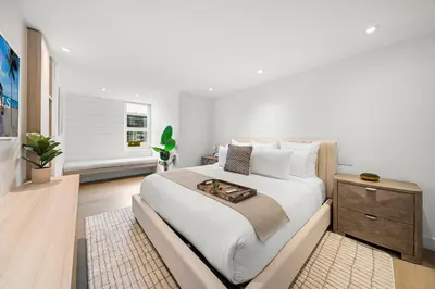 a white bedroom with a large bed with a dresser at 2 Bedroom Private Residence at Roney Palace -630 in Miami Beach