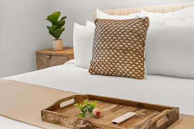 a wooden tray sitting on a bed with a pillow at 2 Bedroom Private Residence at Roney Palace -630 in Miami Beach