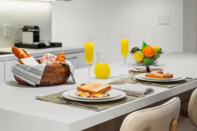 a breakfast table with toast and bread and orange juice at 2 Bedroom Private Residence at Roney Palace -630 in Miami Beach