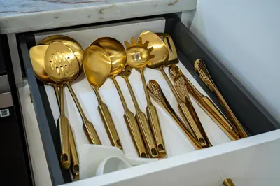 a drawer filled with gold spoons and forks at Chic Villa Nina 2 bedrooms 2 baths in Miami! in North Miami