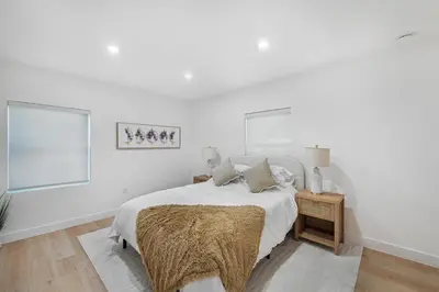 a white bedroom with a bed and two windows at Chic Villa Nina 2 bedrooms 2 baths in Miami! in North Miami