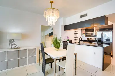 a dining room and kitchen with a table and chairs at Bayside Miami High-Rise Condo By Waterfront Park! in Miami