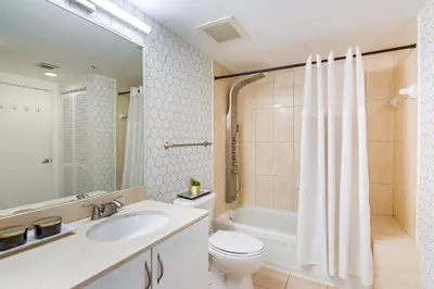 a bathroom with a sink and a toilet and a tub at Bayside Miami High-Rise Condo By Waterfront Park! in Miami