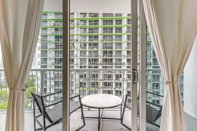 a balcony with a table and chairs and a large window at Bayside Miami High-Rise Condo By Waterfront Park! in Miami