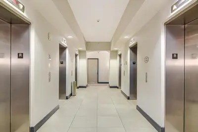 a hallway in a building with elevators and a hallwayngth at Bayside Miami High-Rise Condo By Waterfront Park! in Miami