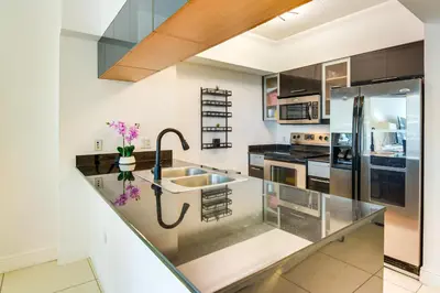 a kitchen with stainless steel appliances and a sink at Bayside Miami High-Rise Condo By Waterfront Park! in Miami