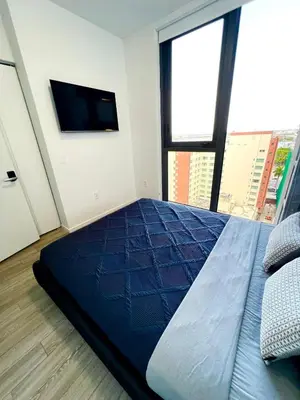 a bedroom with a large bed and a flat screen tv at Miami Downtown 2BR Pool-Gym-Views-Great Location in Miami