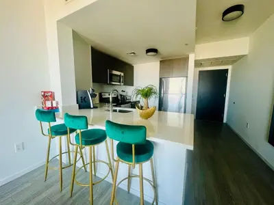 a kitchen with blue bar stools and a counter at Miami Downtown 2BR Pool-Gym-Views-Great Location in Miami