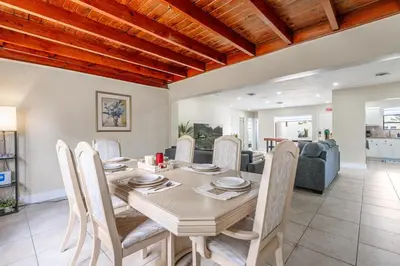 a dining room and living room with a table and chairs at Golden Welcome in Hollywood
