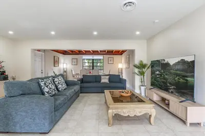 a living room with a blue couch and a table at Golden Welcome in Hollywood
