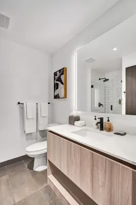 a white bathroom with a toilet and a sink at Lux Miami Studio City Bay Views in Miami