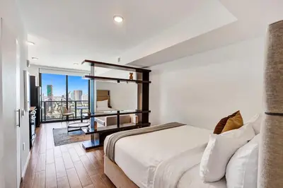 a bedroom with a large bed and a balcony at Lux Miami Studio City Bay Views in Miami