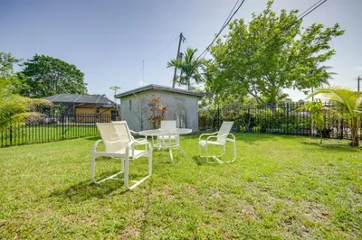 two chairs and a table in a yard at Less Than 3 Mi to Hard Rock Stadium Miami Home with Sunroom in Miami