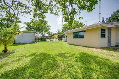 a yard in front of a house at Less Than 3 Mi to Hard Rock Stadium Miami Home with Sunroom in Miami