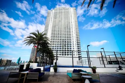 a large white building with palm trees in front of it at 2 BDR Stunning Ocean View in Hyde Beach House in Hollywood