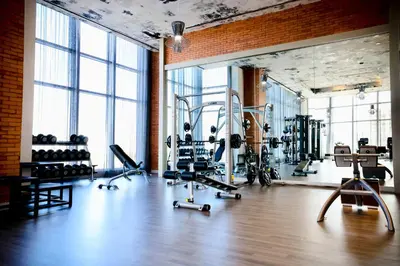 a gym with treadmills and machines in a room with windows at 2 BDR Stunning Ocean View in Hyde Beach House in Hollywood