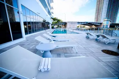 a building with white tables and chairs and a pool at 2 BDR Penthouse Ocean Front View Hyde Beach House in Hollywood
