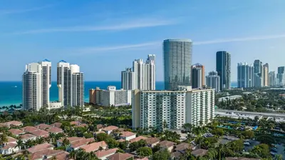 a city skyline with tall buildings and the ocean at Entire Condominium in Sunny Isles in Sunny Isles Beach