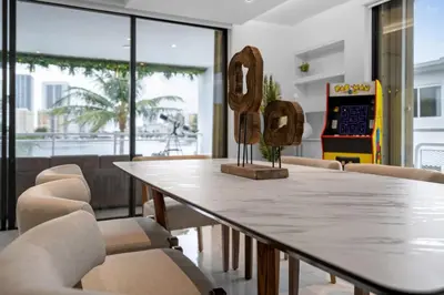 a dining room with a table and chairs at Waterfront 3bed | Pool | 10min walk to Beach in Hallandale Beach