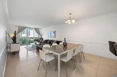 a living room with a table and a couch at Bright Stylish 2BR Condo Stunning View Of Ocean in Sunny Isles Beach