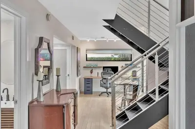 an office with a desk and a staircase in a house at Coconut Grove Haven Family in Miami