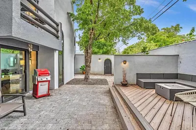 a backyard with a wooden deck with a red stove at Coconut Grove Haven Family in Miami