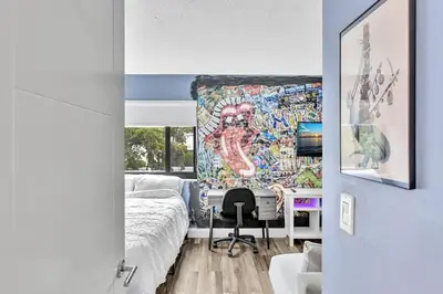 a room with a bed and a desk with a mural at Coconut Grove Haven Family in Miami