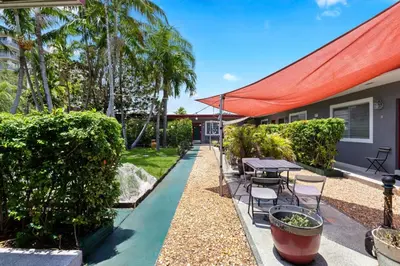 a backyard with a table and chairs and trees at 1BR Studio Parking, Pet Friendly and BBQ Area in Hollywood