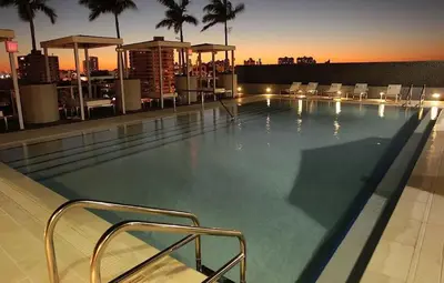 a large swimming pool on top of a building at Large Beach Suite Rooftop Pool by Convention Center in Miami Beach