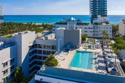 an aerial view of a resort with a pool and the ocean at Large Beach Suite Rooftop Pool by Convention Center in Miami Beach
