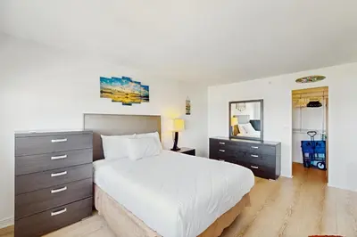 a bedroom with a bed and a dresser and a mirror at Miami Lux Haven in Miami Beach