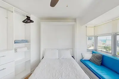 a small bedroom with a bed and a window at Miami Lux Haven in Miami Beach